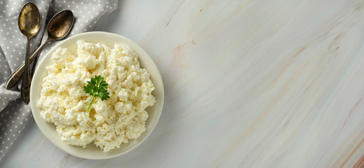 Cottage cheese banner, isoalted on light, marble background. Dairy products, calcium and protein. Healthy breakfast.