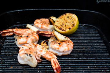 barbecued prawns in a griddle pan cooked with lemon and garlic