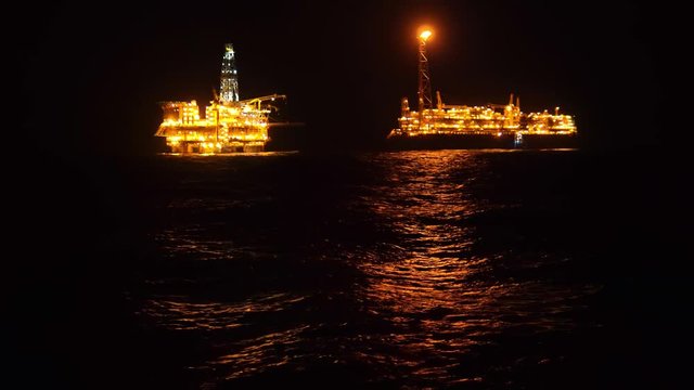 FPSO tanker vessel near Oil platform Rig. Offshore oil and gas industry, sea oil production and storage.