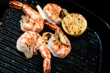 barbecued prawns in a griddle pan cooked with lemon and garlic