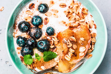 Healthy breakfast - yoghurt, oat flakes, blueberries and apples