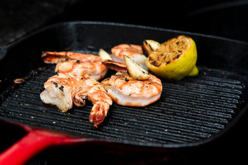 barbecued prawns in a griddle pan cooked with lemon and garlic