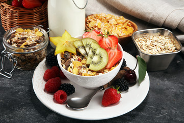 Healthy breakfast. Bowl of yogurt with granola and berries, fresh fruits and milk