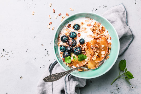 Healthy breakfast - yoghurt, oat flakes, blueberries and apples