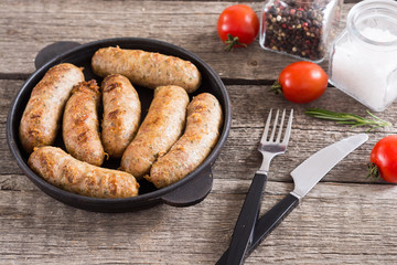 Grilled sausages with tomatoes , pepper and rosemary