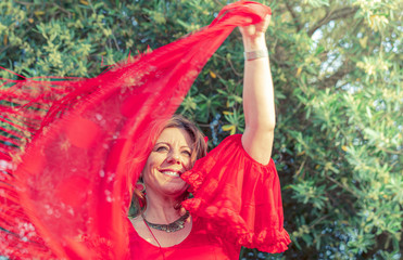 Flamenco dancer in red dress and with spanish shawl dancing