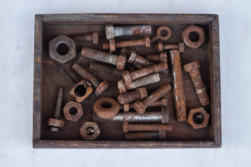 Background from old rusty bolts, screws, nuts, screws, brackets, various metal details. Rusty set of hand tools. White background. Vintage tools. Artisan work concept.