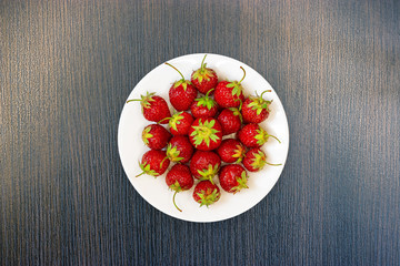 strawberries on dish / bright juicy berry close-up