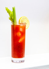 freshly made Bloody Mary cocktail or tomato juice, garnished with celery and lemon