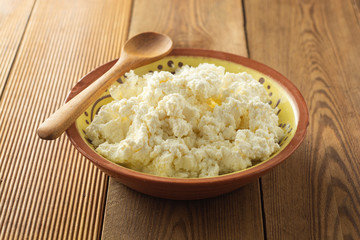 Cottage cheese isoalted on wooden background. Dairy products, calcium and protein. Healthy breakfast.