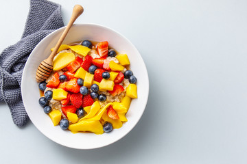 Homemade porridge served with fruits and berries