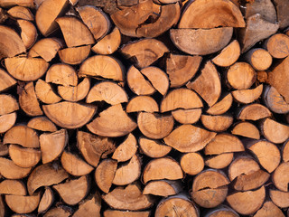 Stack of firewood. Pile of brown wood logs.