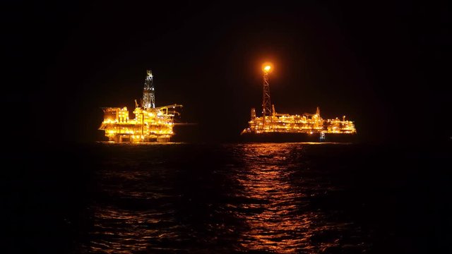 FPSO tanker vessel near Oil platform Rig. Offshore oil and gas industry, sea oil production and storage.