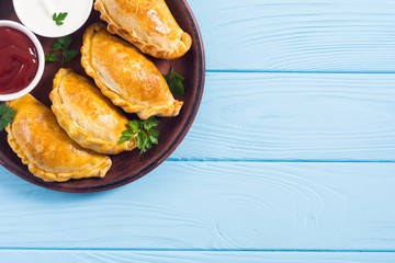 Latin American baked beef empanadas with sauce