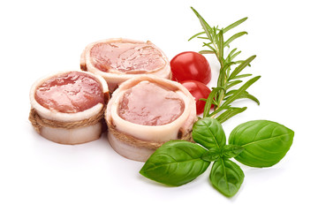 Raw meat medallions wrapped in bacon, close-up, isolated on white background