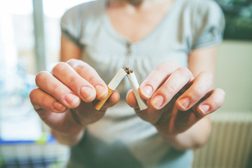 Quit Smoking . Female Hands Hold Broken Cigarette.  Unrecognizable Person . Stop Bad Habit ....