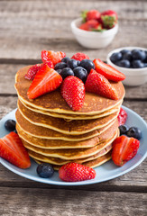 Tasty pancakes with blueberry and strawberry