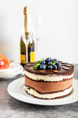 Belgian Chocolate Layered Gateau. Layers of moist choco sponge, vanilla cream and indulgent dark chocolate mousse glazed with rich dark chocolate sauce and hand decorated with fresh blueberries