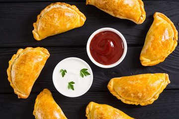 Latin American baked beef empanadas with sauce