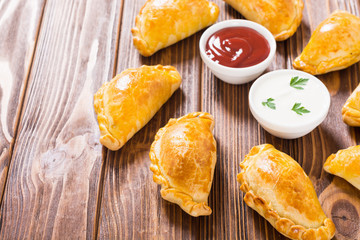 Latin American baked beef empanadas with sauce