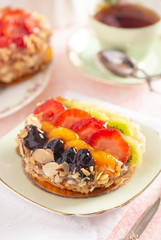 French Fruit Pastry on a China Plate on a Table Set for Tea