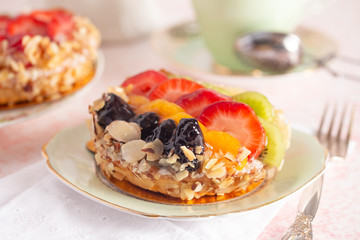 French Fruit Pastry on a China Plate on a Table Set for Tea