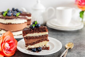 Belgian Chocolate Layered Gateau. Layers of moist choco sponge, vanilla cream and indulgent dark chocolate mousse glazed with rich dark chocolate sauce and hand decorated with fresh blueberries