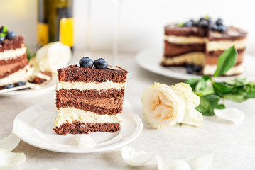 Belgian Chocolate Layered Gateau. Layers of moist choco sponge, vanilla cream and indulgent dark chocolate mousse glazed with rich dark chocolate sauce and hand decorated with fresh blueberries