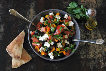 Fresh salad with vegetables, parsley and white cheese.