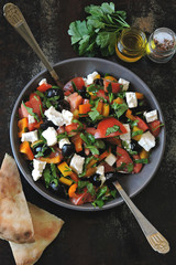 Fresh salad with vegetables, parsley and white cheese.