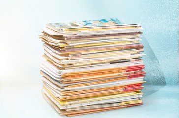 Pile of newspapers on white background