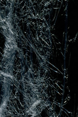 Transparent plastic wrap on the black background. Plastic bag texture. Reusable trash and waste.