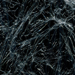 Transparent plastic wrap on the black background. Plastic bag texture. Reusable trash and waste.