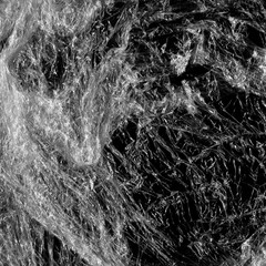 Transparent plastic wrap on the black background. Plastic bag texture. Reusable trash and waste.