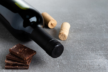 Wine and chocolate on concrete background. Copy Space.