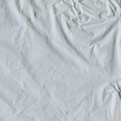 Transparent plastic wrap on the black background. Plastic bag texture. Reusable trash and waste.
