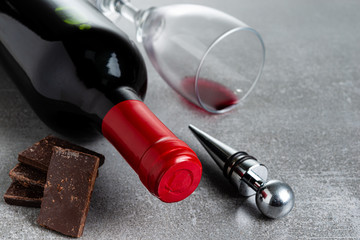 Wine and chocolate on concrete background. Copy Space.