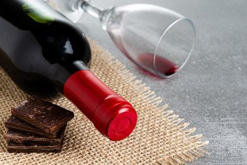 Wine and chocolate on concrete background. Copy Space.
