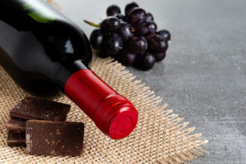 Wine and chocolate on concrete background. Copy Space.