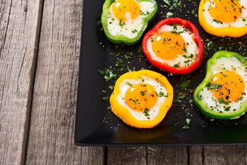 Yellow , red and green pepper with fried eggs