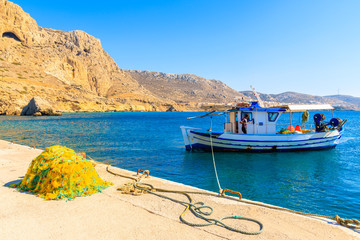 Fototapeta na wymiar Fishing boat in picturesque Finiki port with mountains in background, Karpathos island, Greece