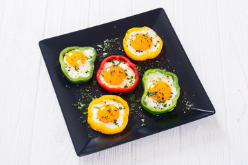 Yellow , red and green pepper with fried eggs