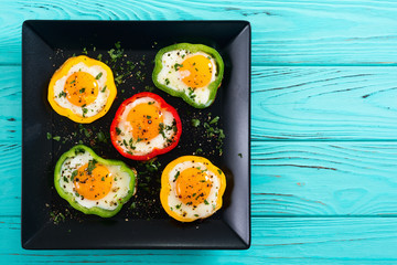 Yellow , red and green pepper with fried eggs
