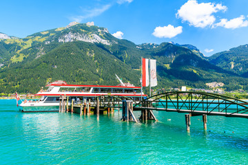Tourist ship mooring at pier on shore of Achensee lake on sunny summer day, Pertisau, Tirol, Austria