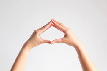 Hands pose tip of fingers splice to be spade shape frame on white background.