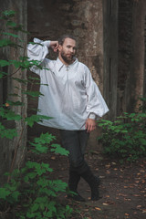 Handsome man in medieval costume standing