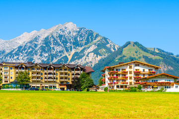 Green meadow with typical houses in background in Pertisau town, Achensee lake, Tirol, Alps Mountains, Austria