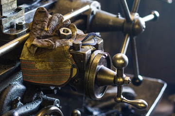 Glove with a nut on a machine