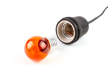 Close up Orange Incandescent round light bulb and ceramic Lamp Holders covered with black rubber isolated on white background.