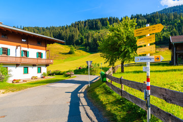 TIROL, AUSTRIA - JUL 29, 2018: Signs with walking and bike trails in beautiful alpine village of Going am Wilden Kaiser on sunny summer day, Tirol, Austria.